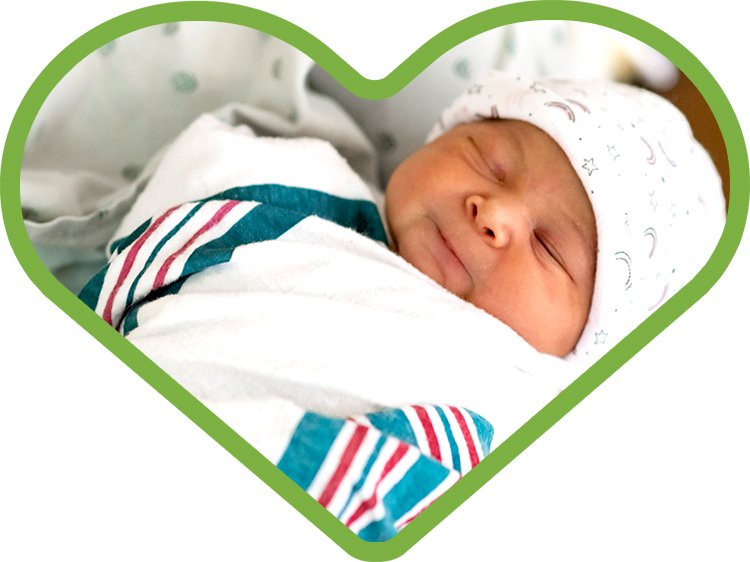 Photo of a newborn baby in a green heart
