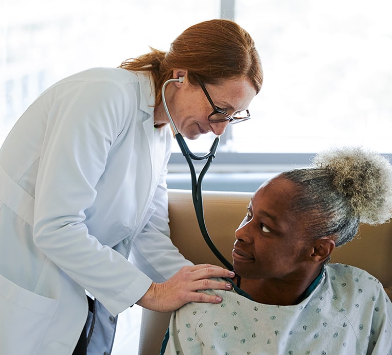 A doctor listening to a patient's breathing