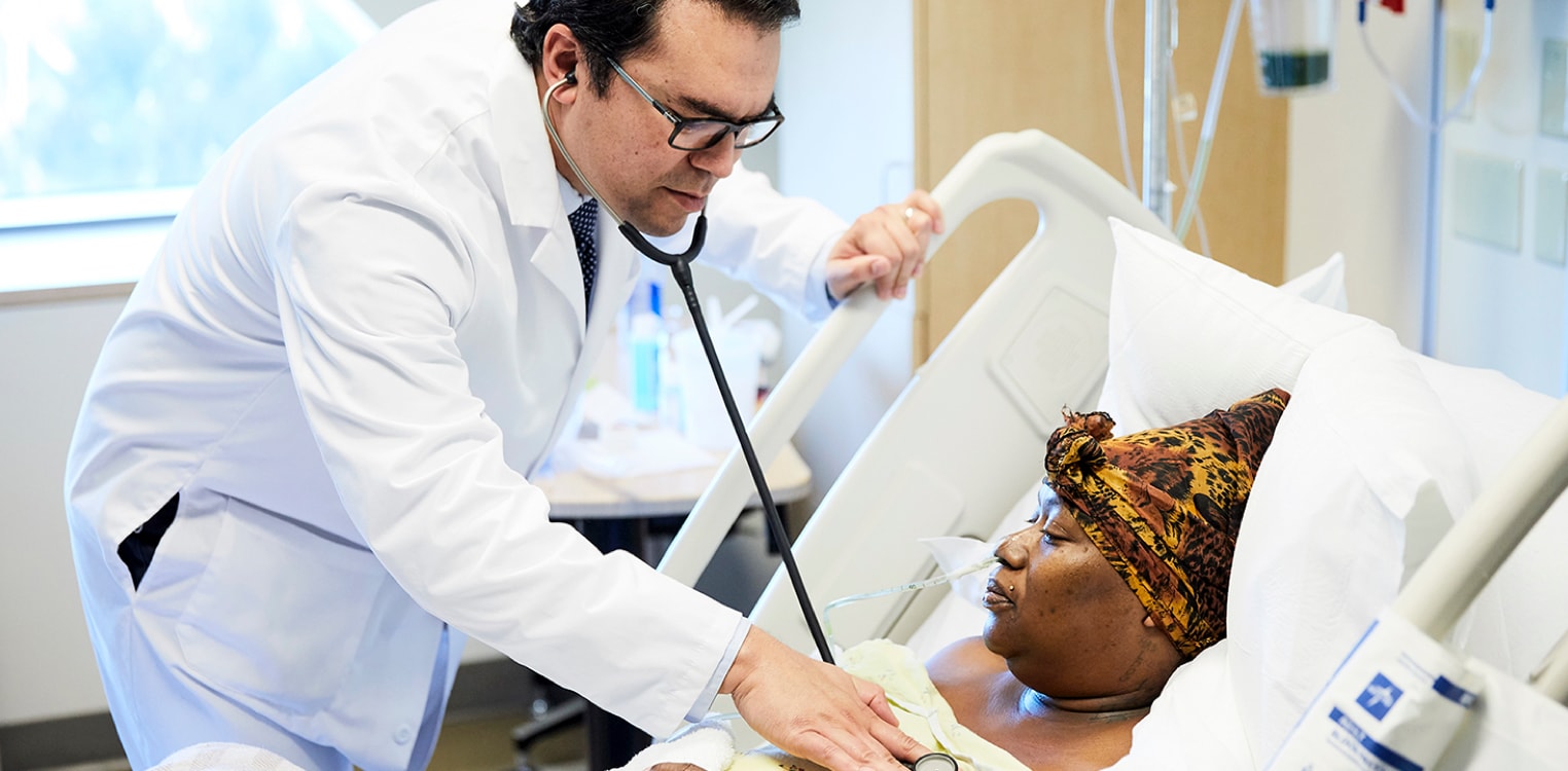 A doctor listens to a patient's breathing