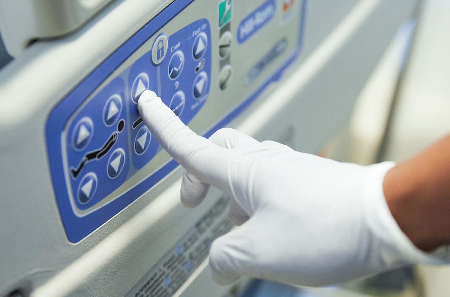 Closeup of a nurse’s finger adjusting position on a smart bed