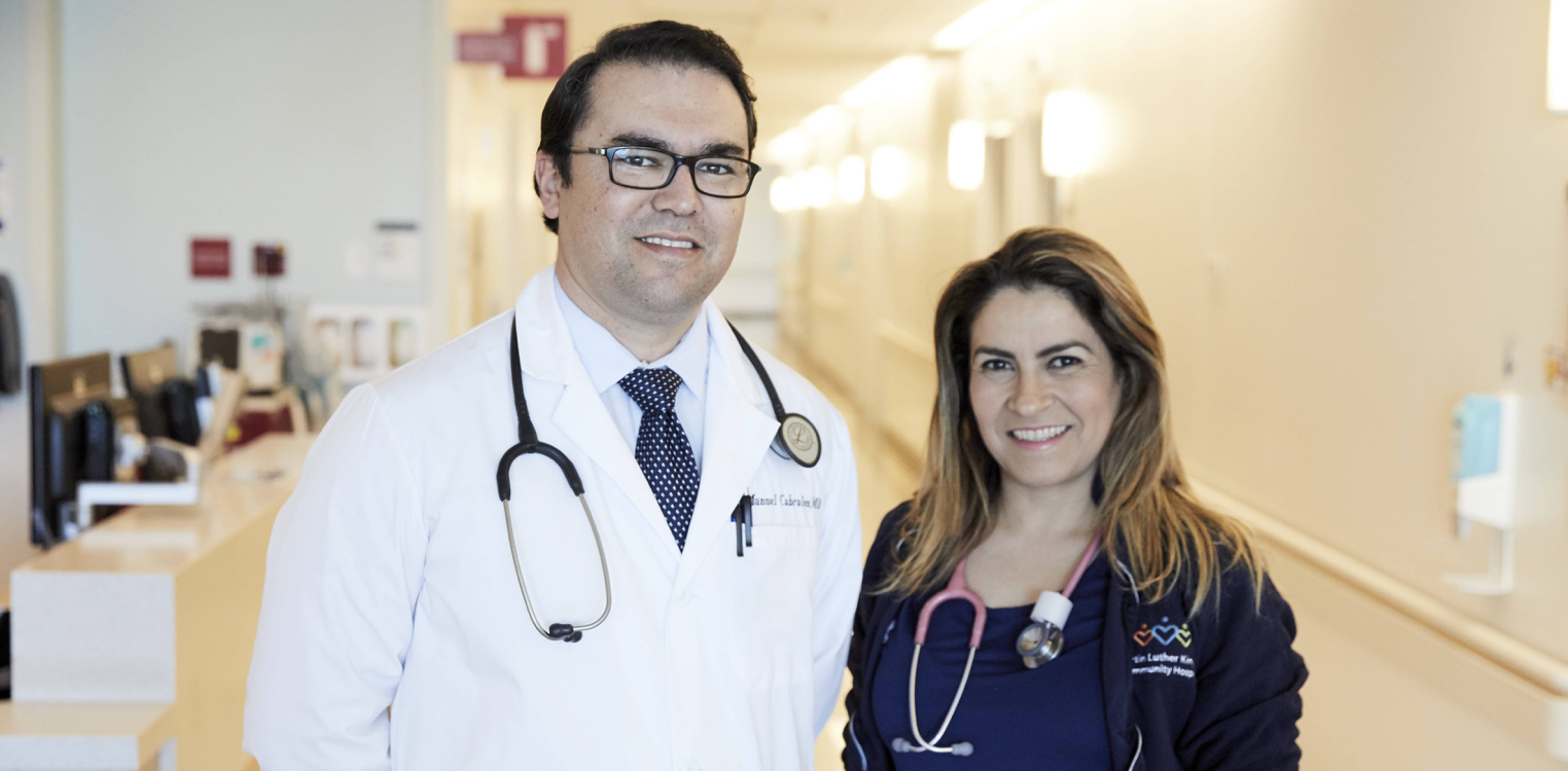Smiling physician and smiling nurse side by side