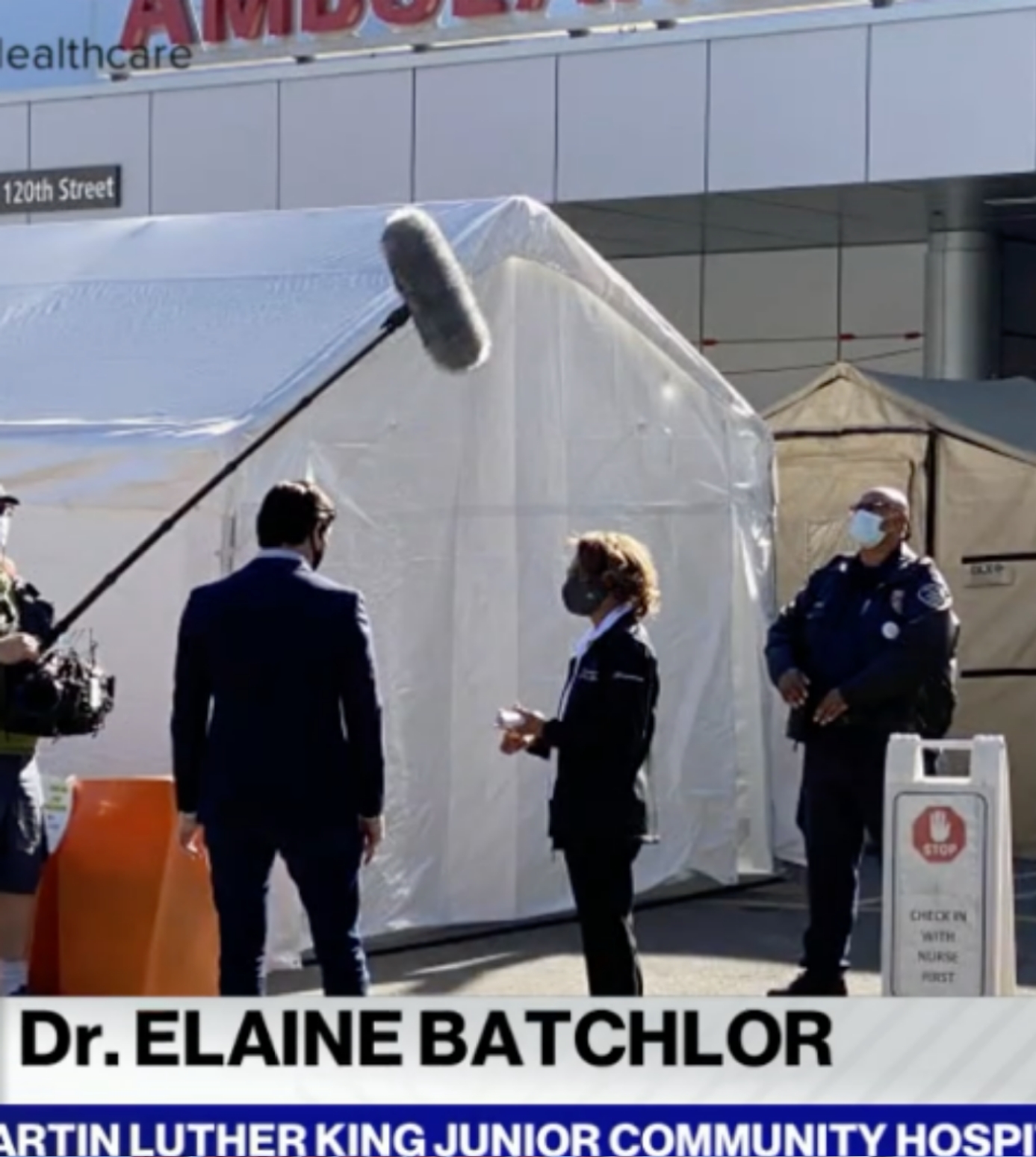 Photo of Dr. B in front of tents