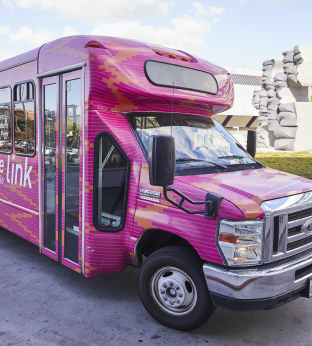 Close up of a small pink transport van