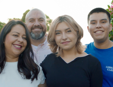 Photo of Rev. Rudy Rubio standing with his family