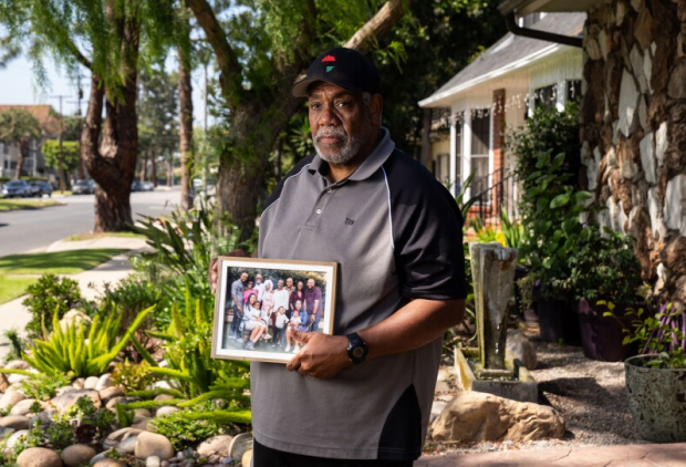 Photo of African American man holding a photo