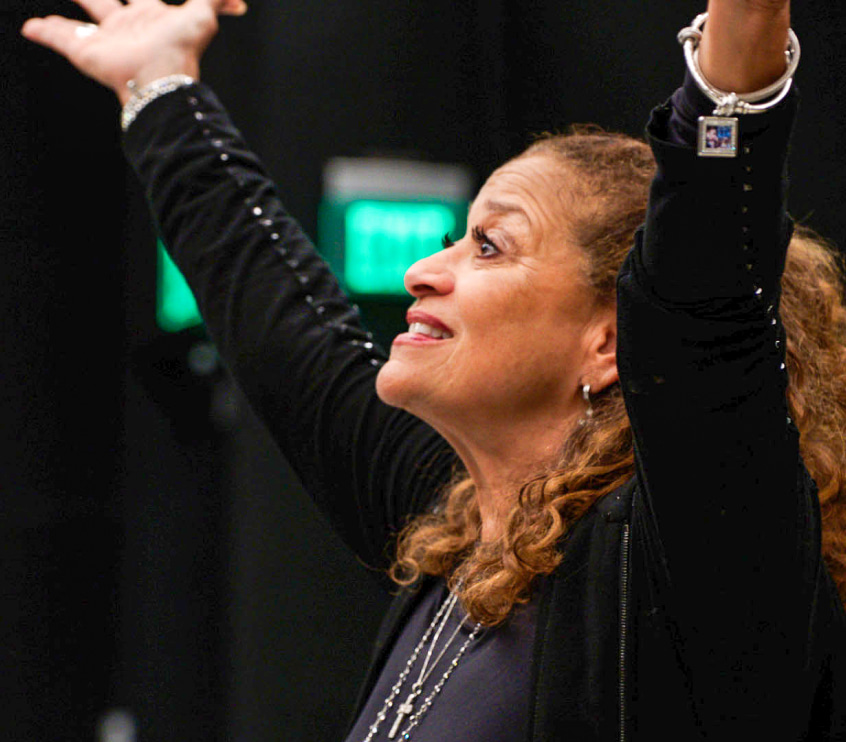 Debbie Allen with hands raised in the air