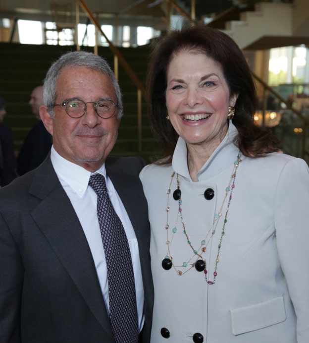 An older white man and older white woman standing together at the Dream Lunch