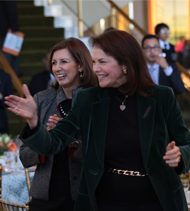 Two older white woman in profile laughing at the Dream Lunch