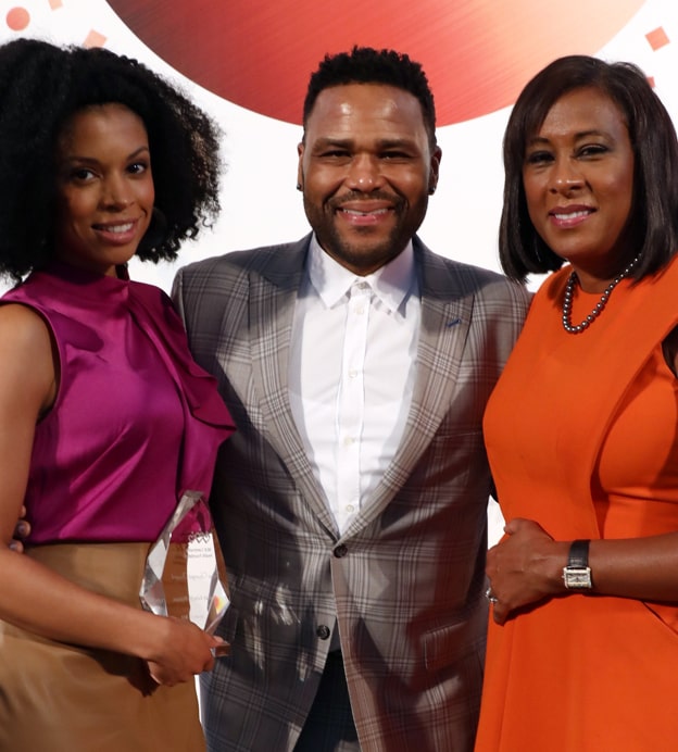 Susan Kelechi Watson, a middle-aged Black woman, stands next to Anthony Anderson, a middle-aged Black man, and Pat Harvey, a middle-aged Black woman