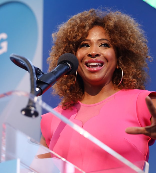 Close up of Tanika Ray, a young Black woman in a pink dress