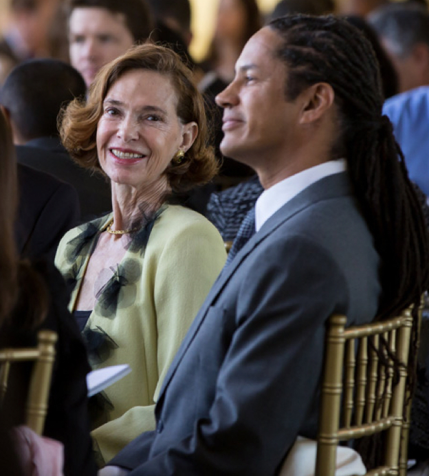 Middle-aged white woman looks at middle-aged Black man while seated at the Dream Lunch