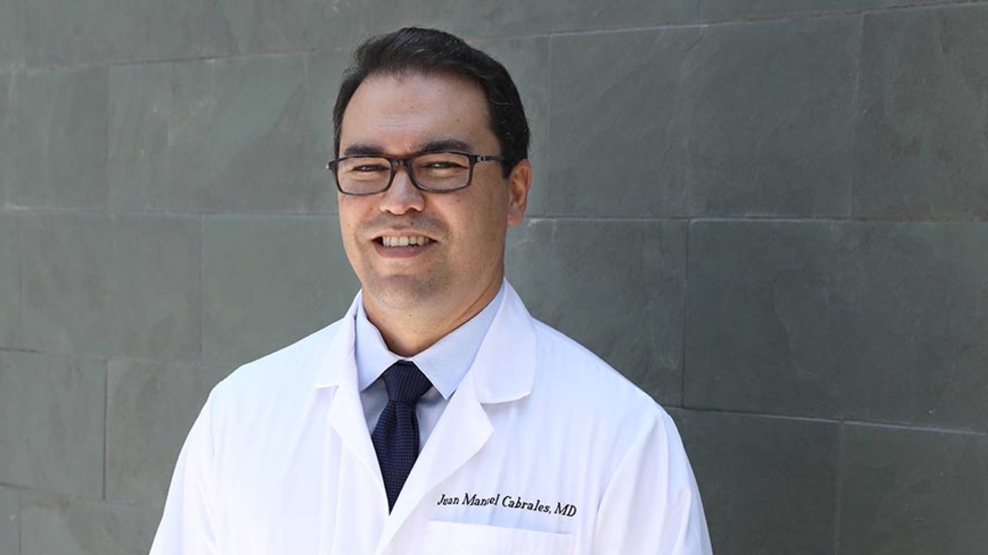 Smiling portrait of young Latino doctor Dr. Juan Cabrales