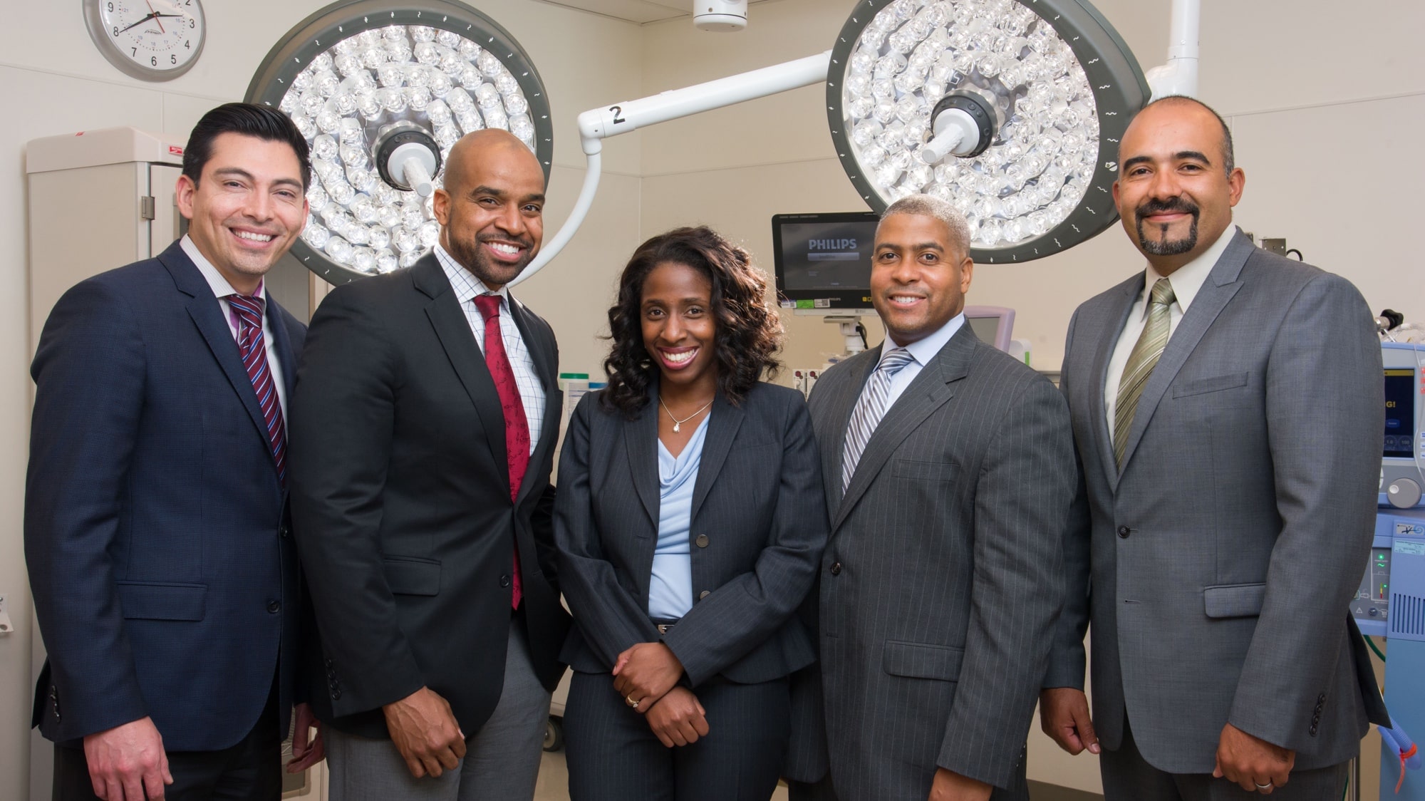 Five hospital leaders in suits 