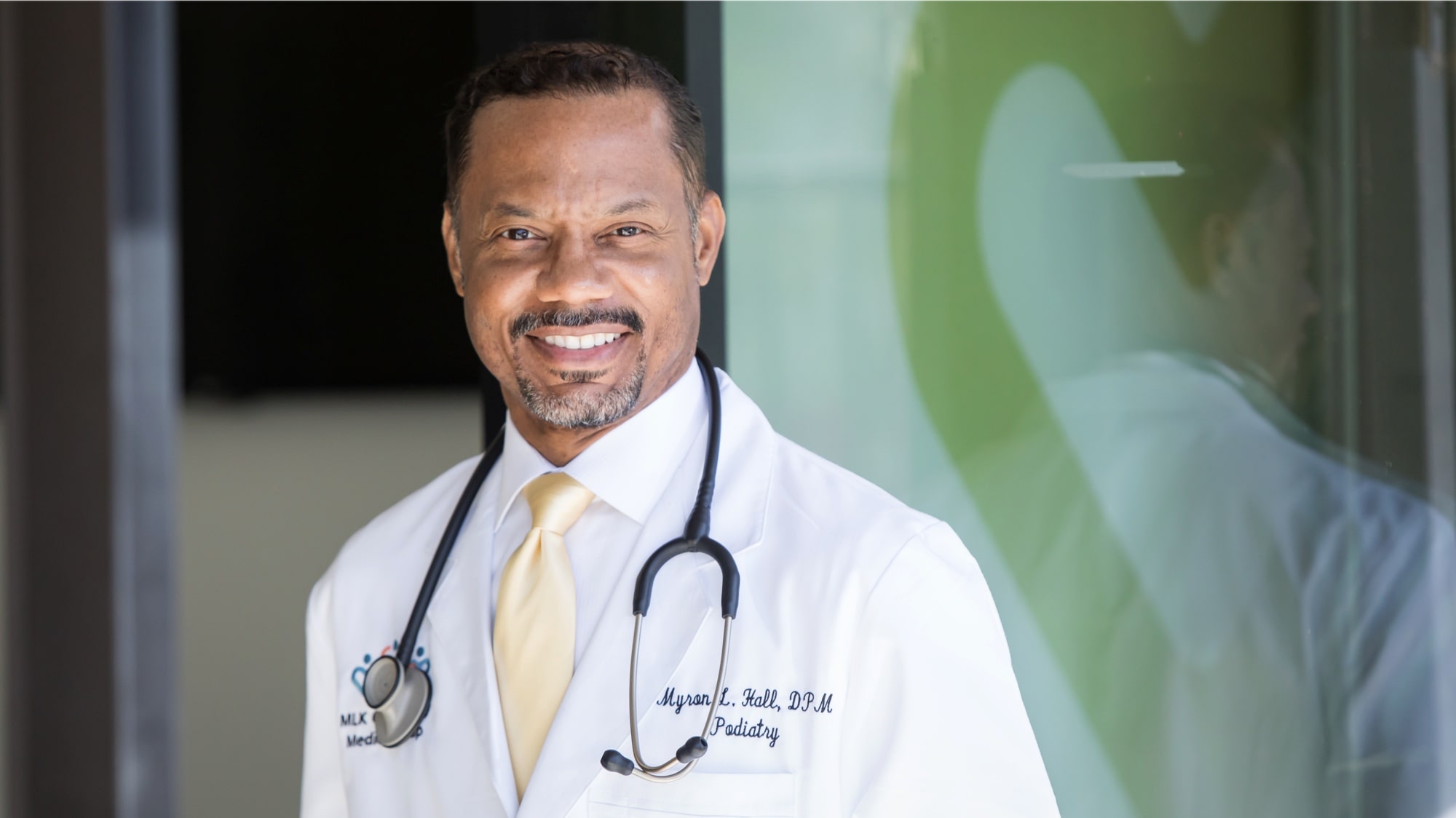 Middle-aged black doctor Dr. Myron Hall smiling