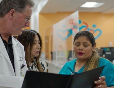 Doctor standing with two nurses