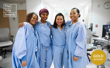 A group of nurses huddled together on the hospital floor