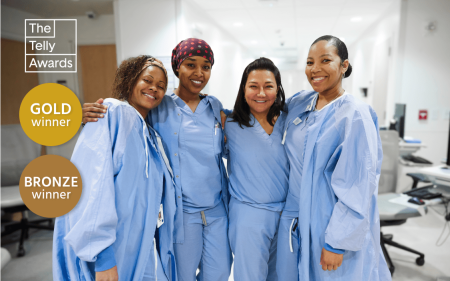 A group of nurses huddled together on the hospital floor
