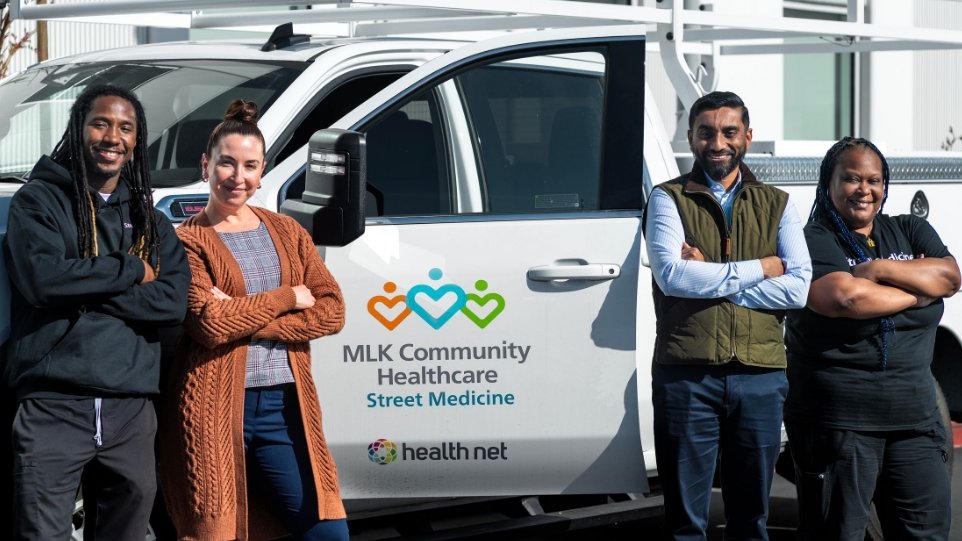 Photo of diverse street medicine team in front of street medicine truck