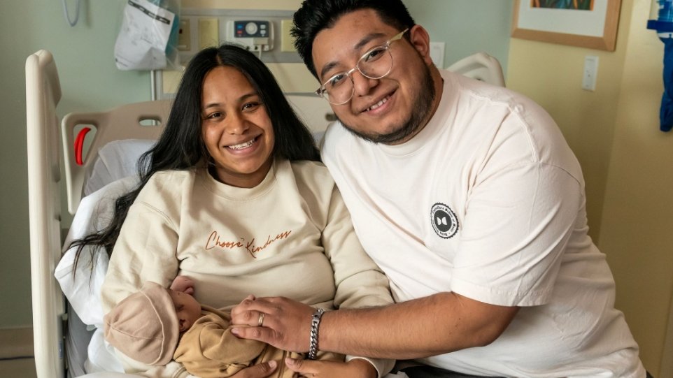 Photo of Hispanic couple with newborn