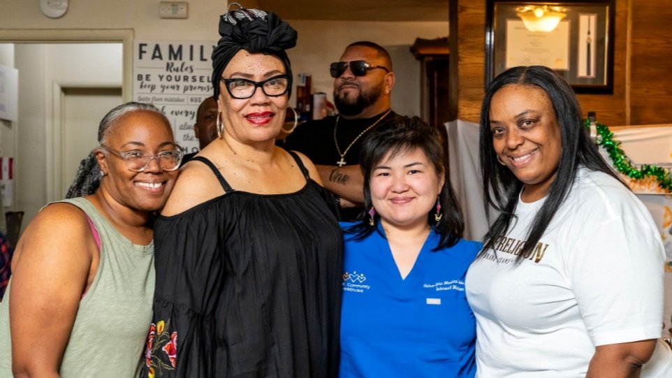 2 Black women with an asian woman smiling 