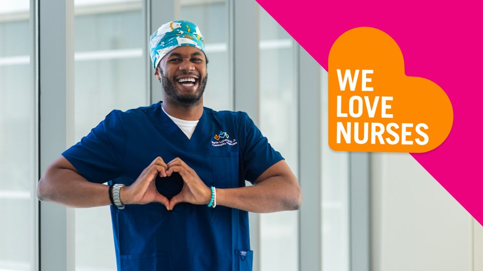 Male nurse smiling with heart hands