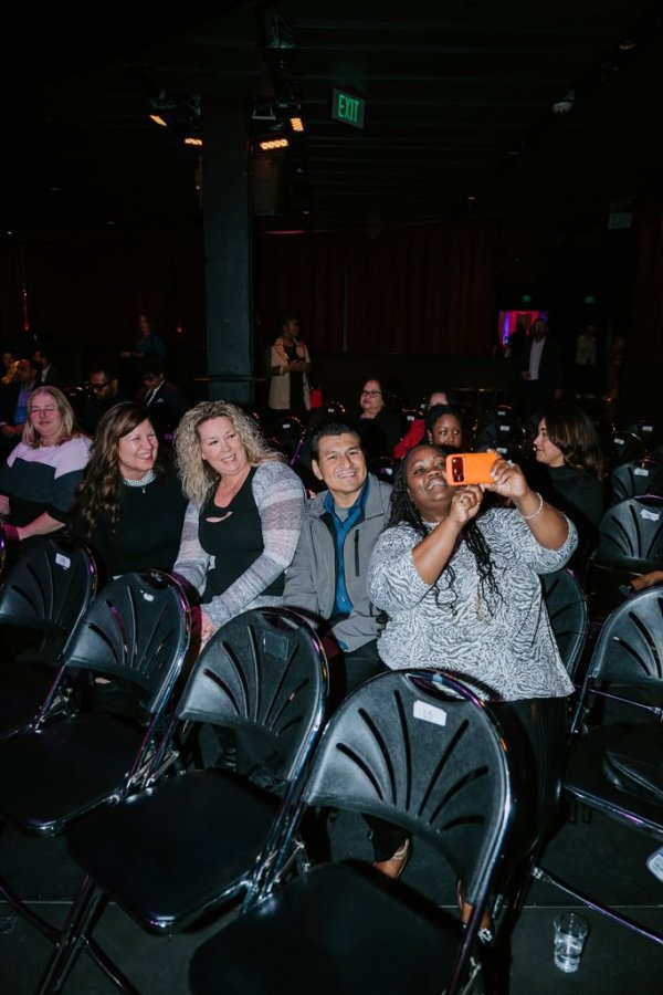 row of people smiling in chairs