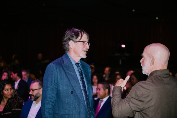 2 men speaking to each other