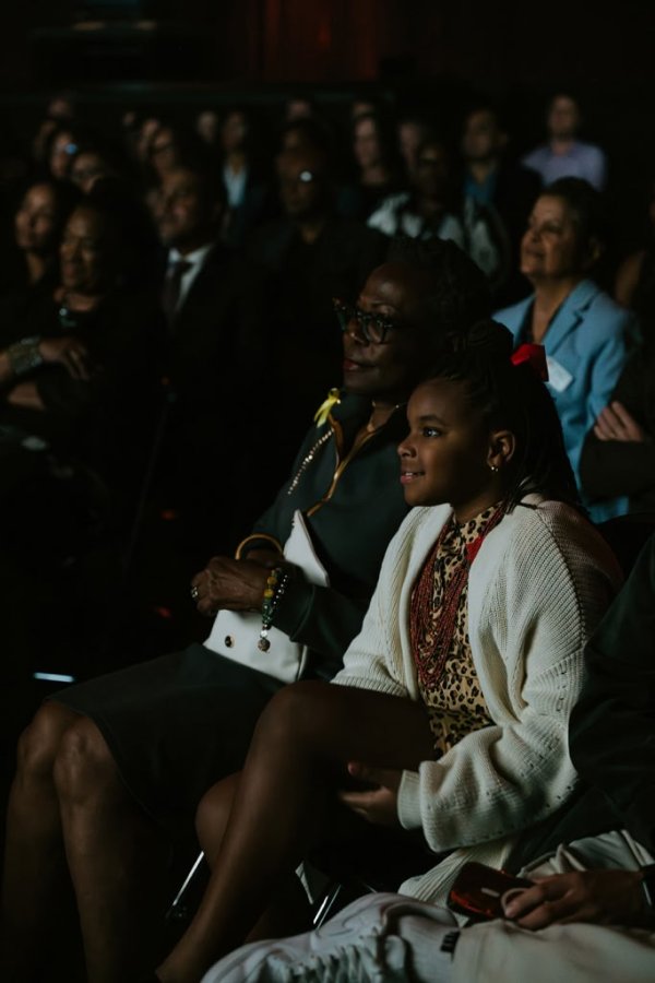 woman and child smiling watching screen