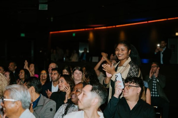 woman standing and smiling in crowd