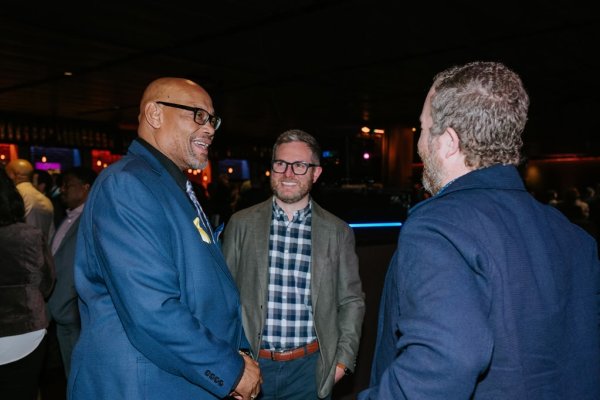 group of men talking and smiling