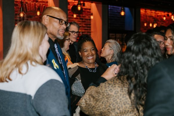 group of people smiling and talking