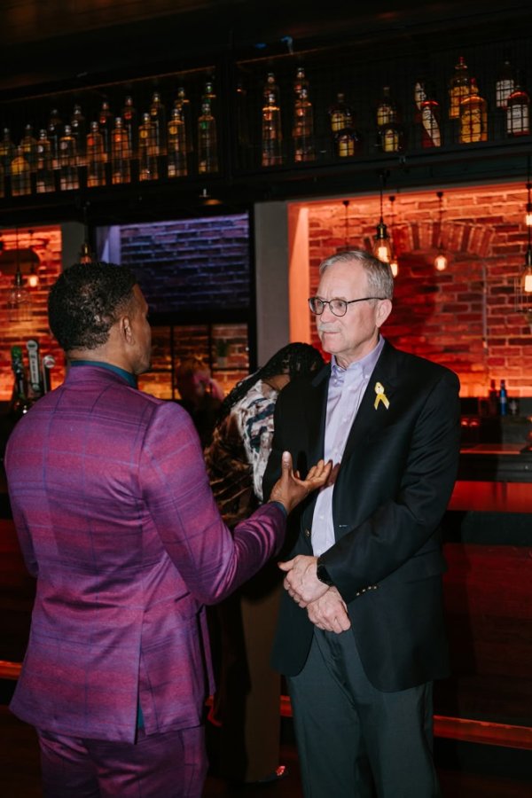 group of people smiling and talking