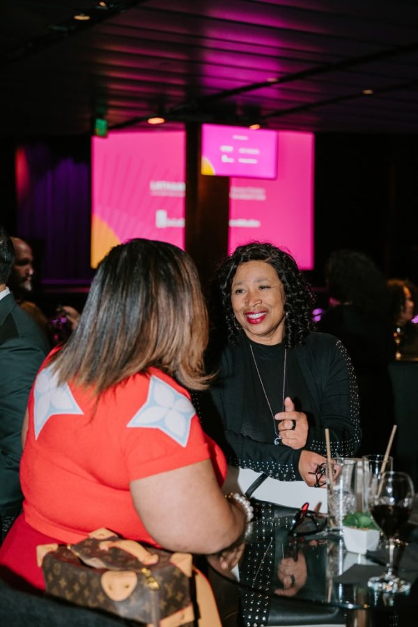 2 women smiling and talking