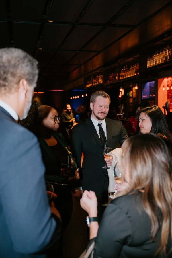 group of people smiling and talking