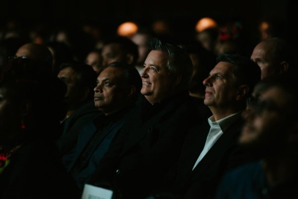 group of people smiling at theatre screen
