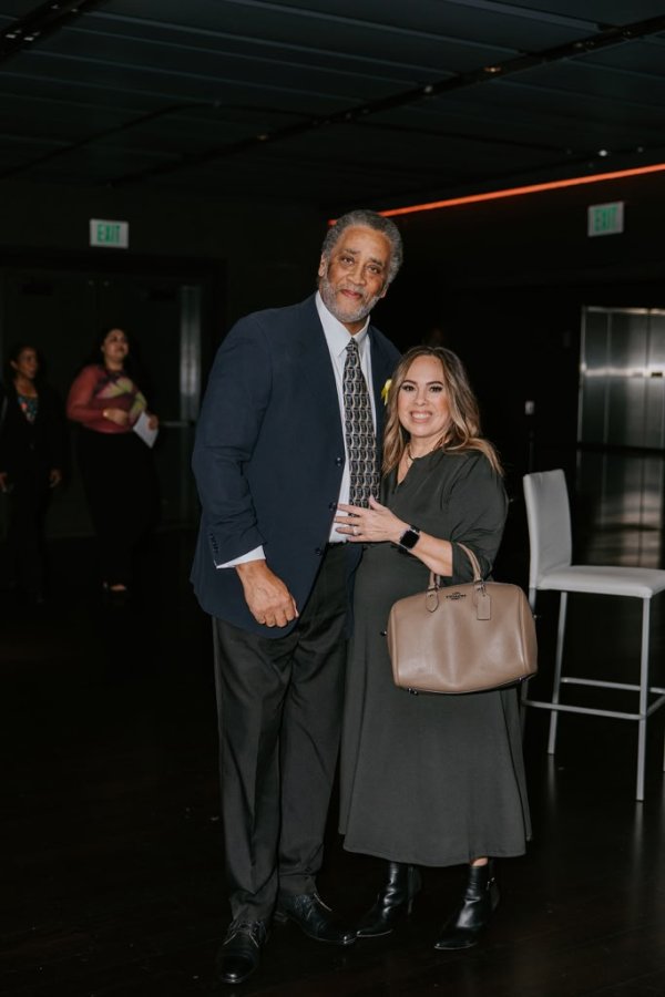 man and woman standing and smiling for a photo