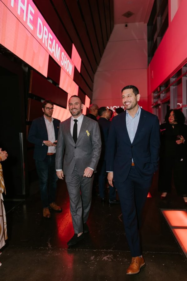 2 men walking into lobby