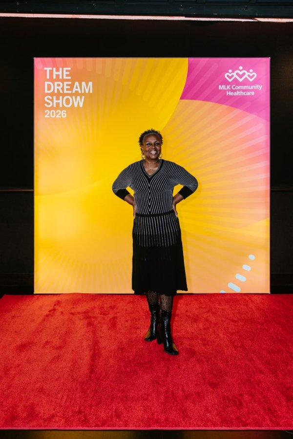 woman smiling in front of photo backdrop