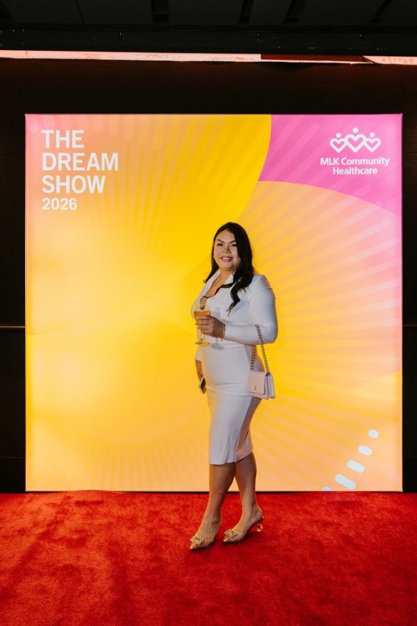 woman smiling in front of photo backdrop