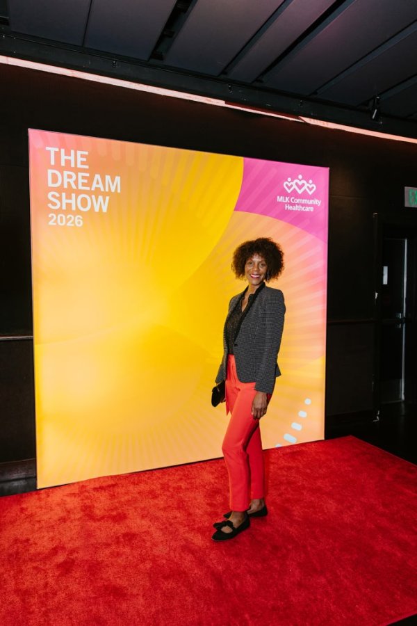 woman smiling in front of photo backdrop