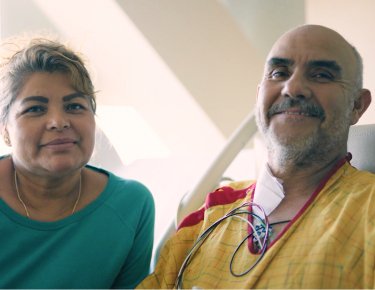 Latino male patient and his wife smiling