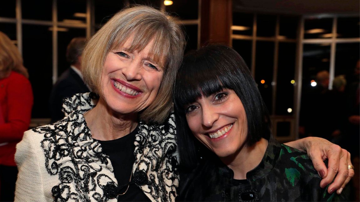 Two women hugging and smiling