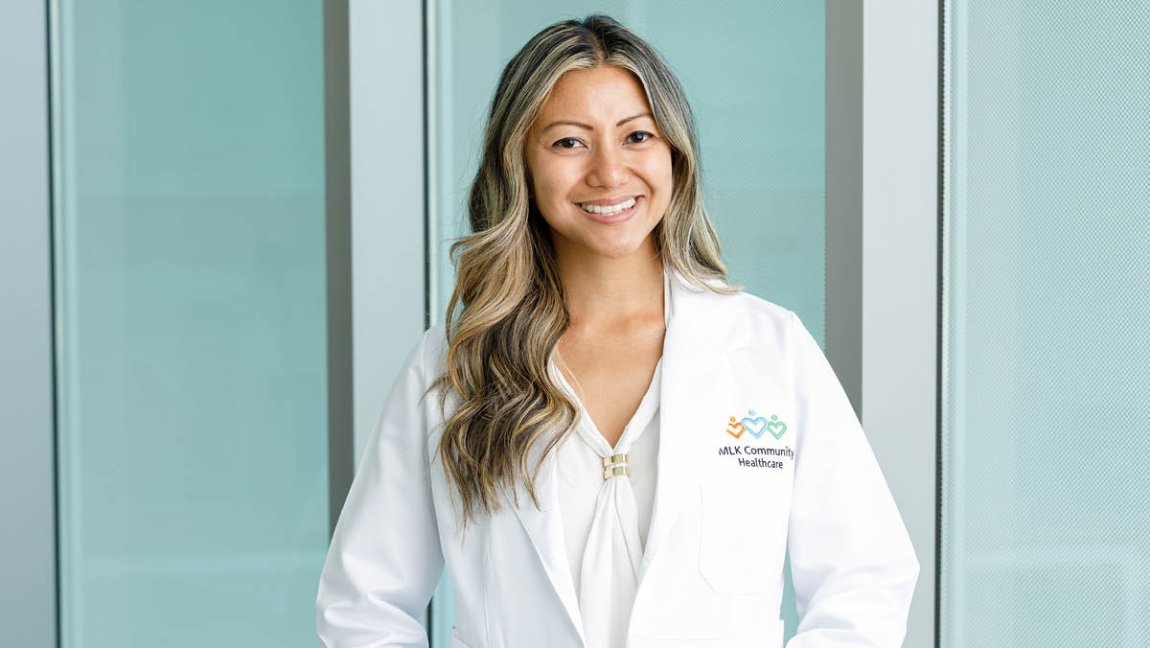 Woman smiling with a doctors coat