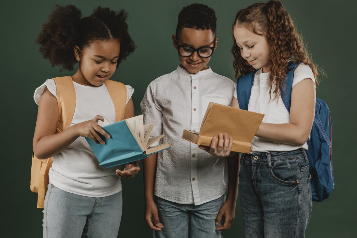 school-colleagues-looking-through-books-together.jpg - Credit: Freepik