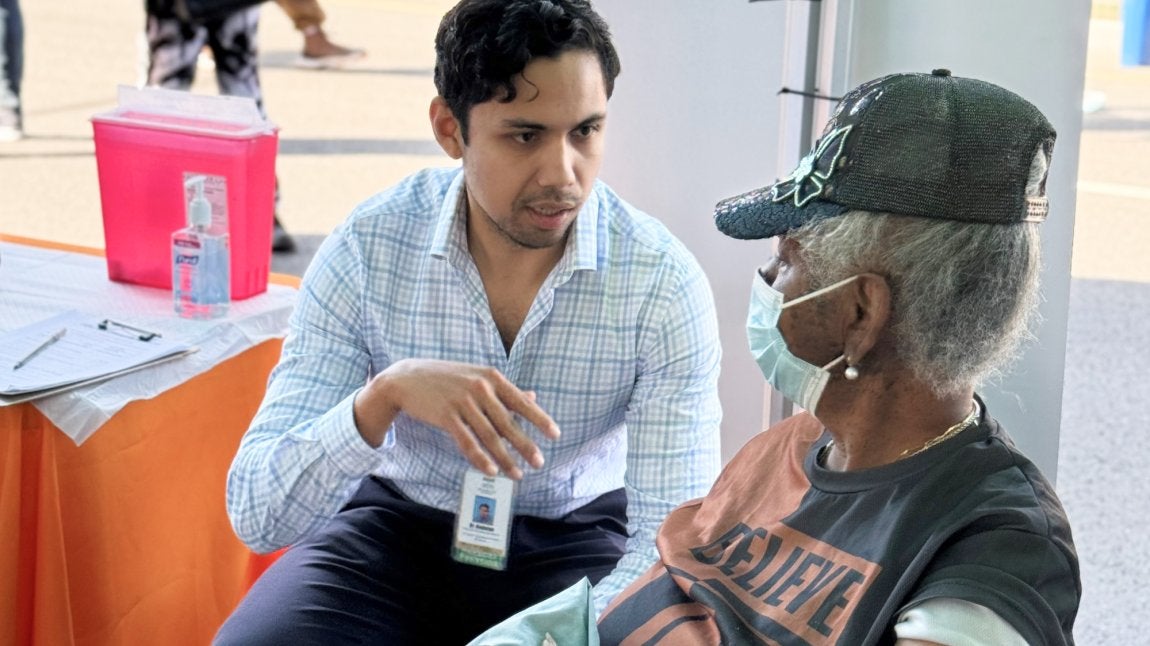 Dr. Adalon with a patient at a health fair