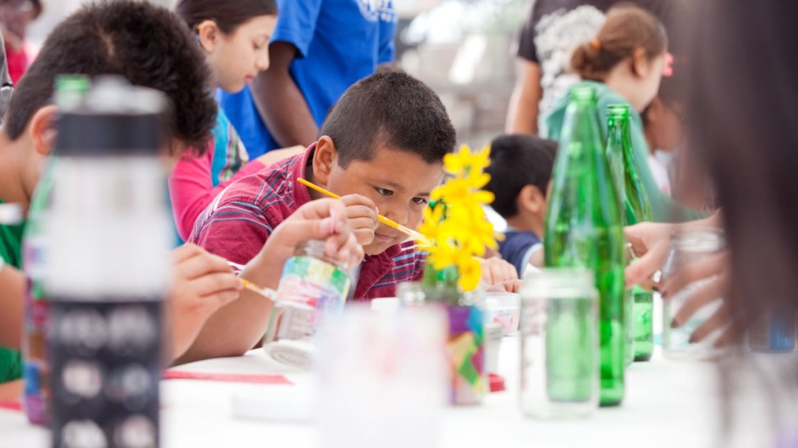 Child painting at outdoor event