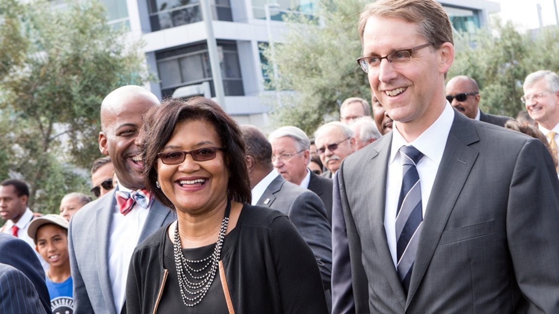 Dr. Elaine Batchlor and Manny Abascal smiling in a crowd