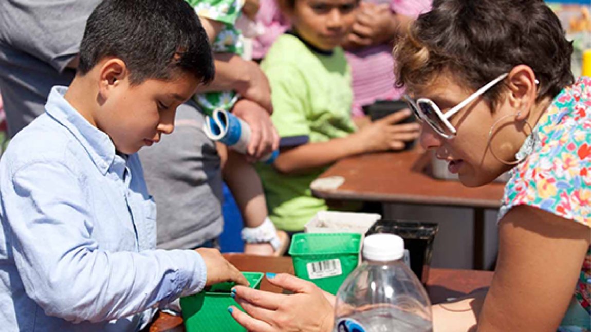 Young boy at a tabling at an outdoor event