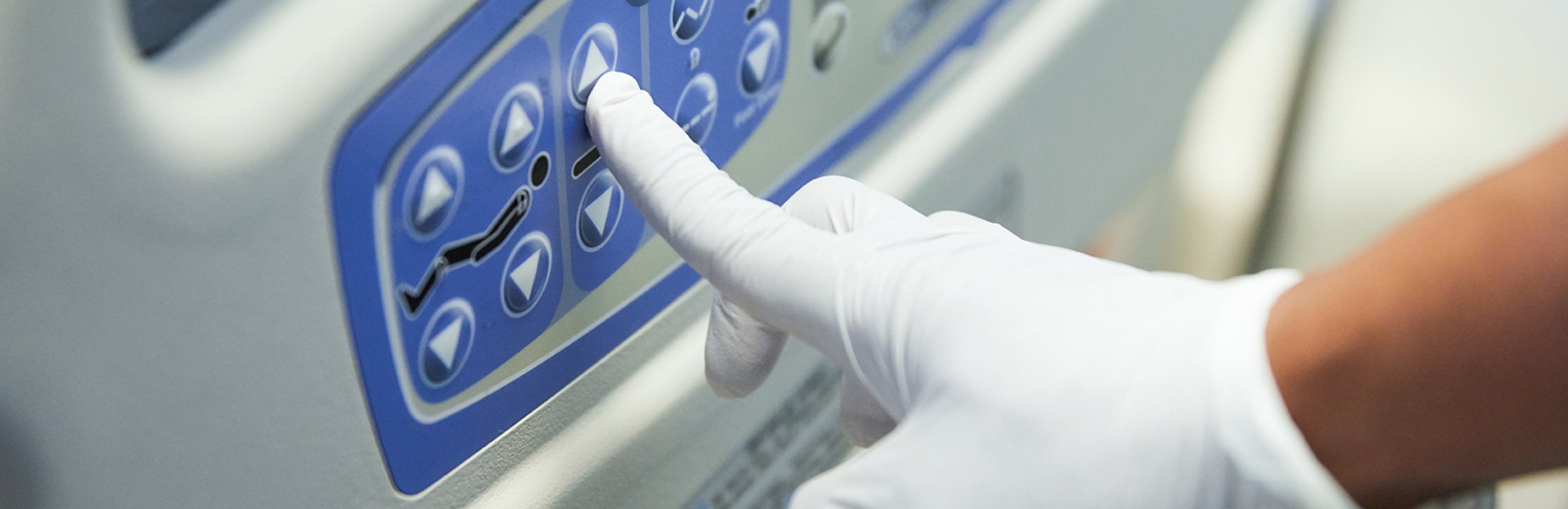 Closeup of a nurse’s finger adjusting position on a smart bed