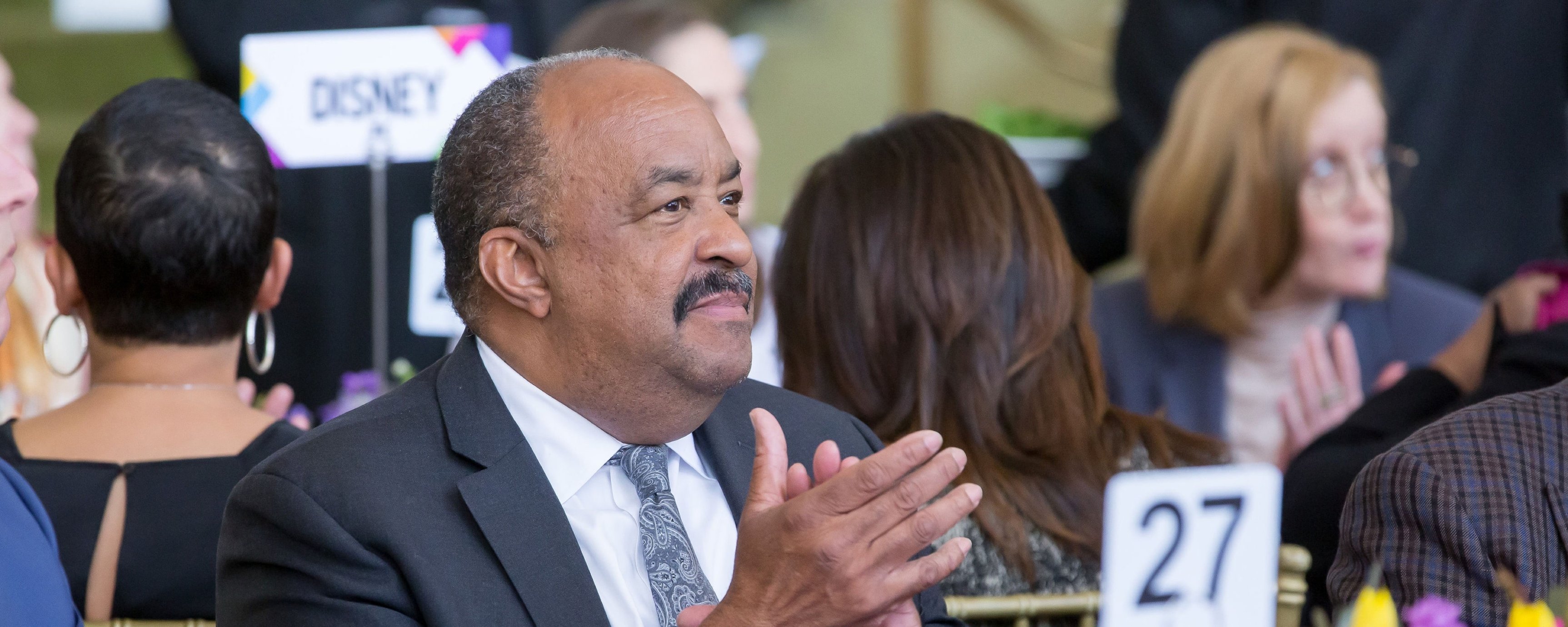 Close up of Dr. Bob Ross, an older Black man, seated at the event